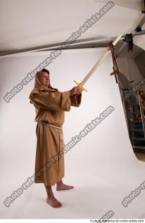 JOEL_ADAMSON STANDING POSE WITH SWORD AND CRUCIFIX